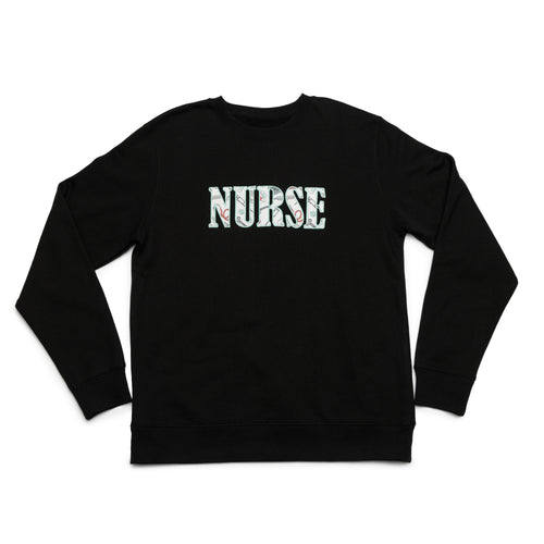 Black crewneck laid flat with the Nurse design appliqued on the chest