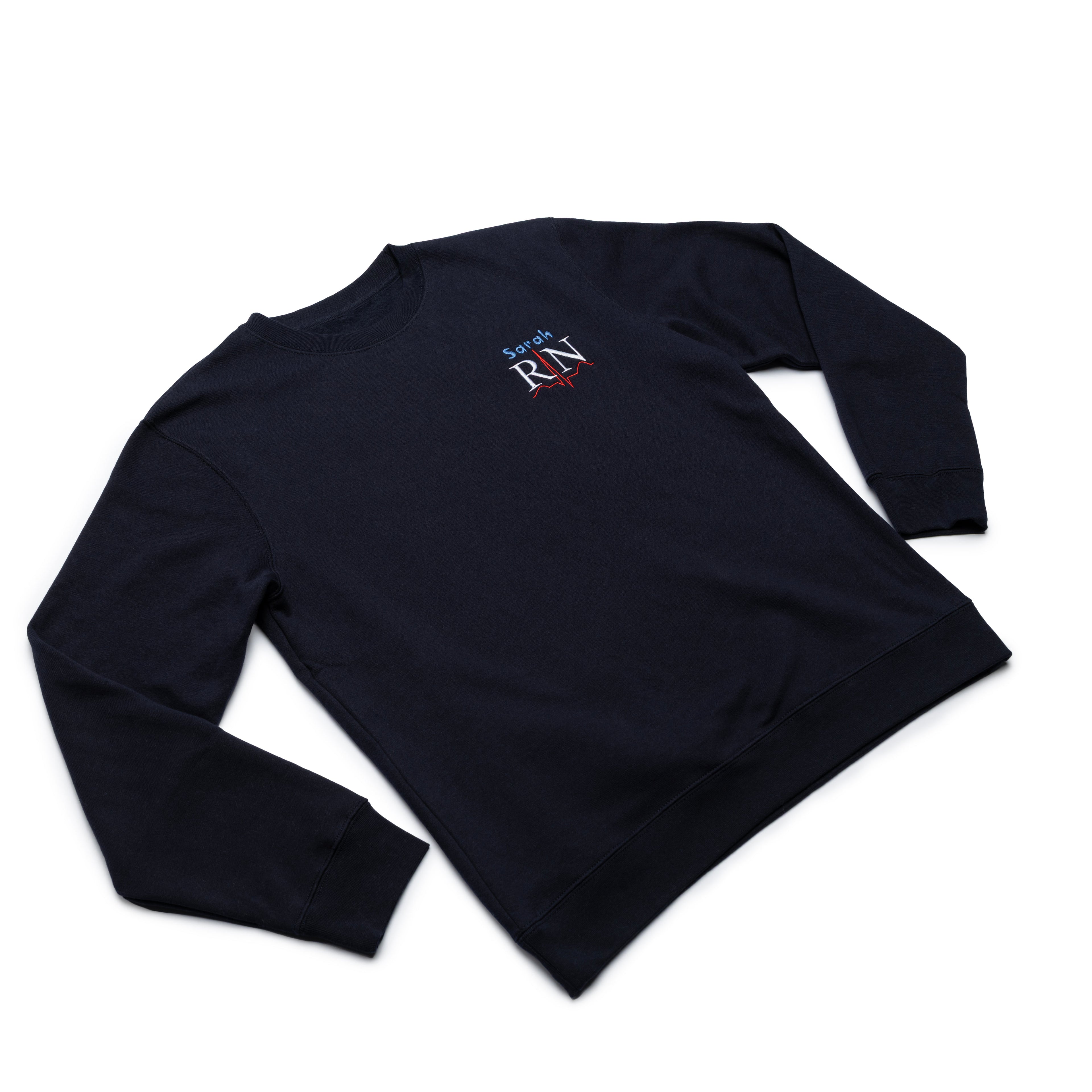 Classic Navy crewneck worn at an angle with a custom name and the RN design embroidered on the chest