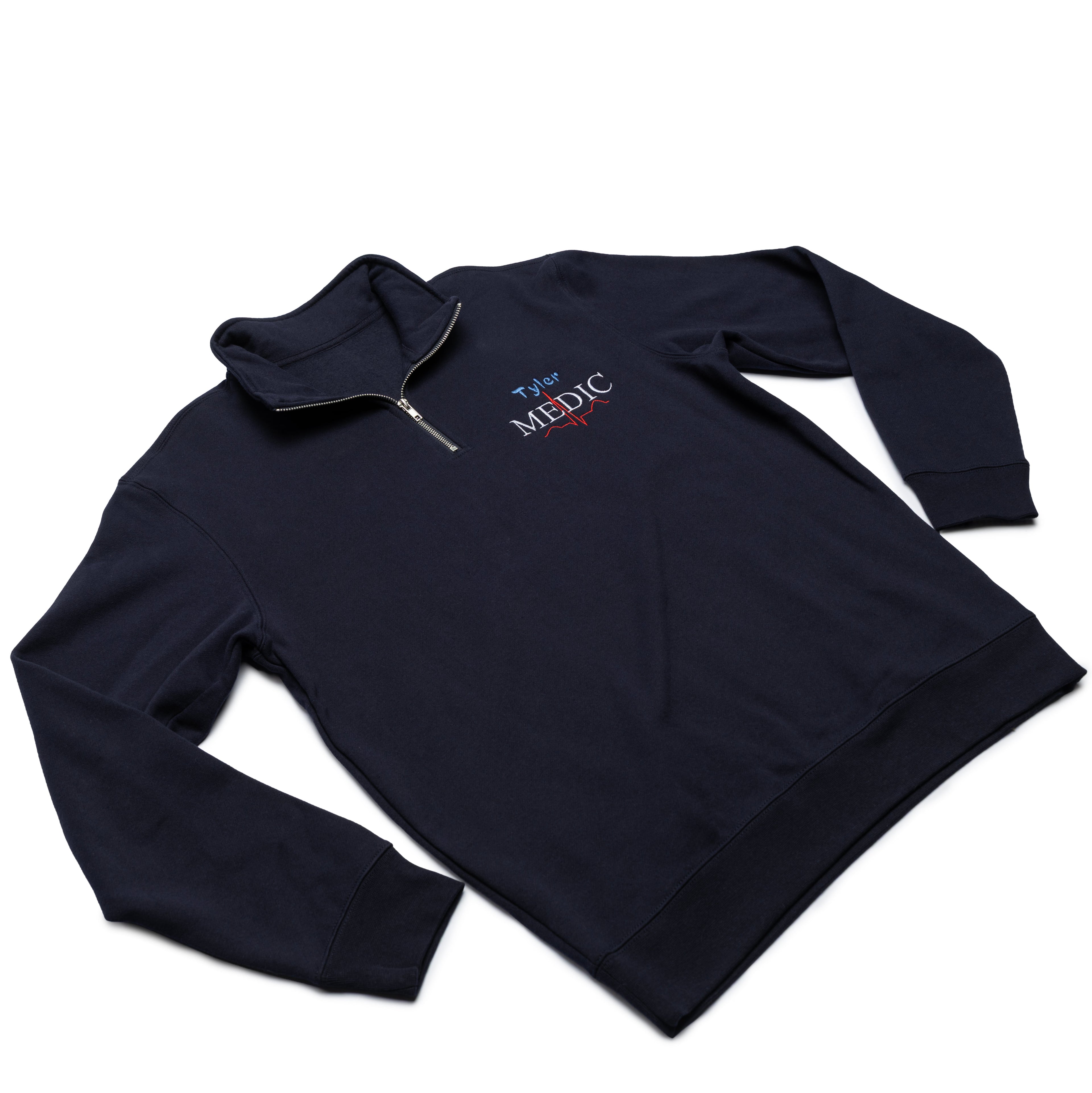 Classic Navy quarter-zip worn at an angle with a custom name and the Medic design embroidered on the chest