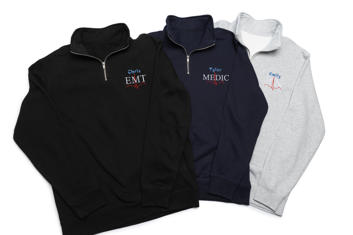 Three Lead II quarter-zips stacked together, each personalized with a name and credential design