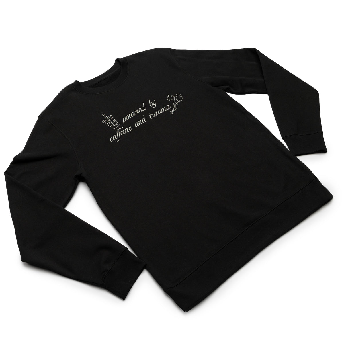 Black crewneck worn at an angle with the Powered by Caffeine and Trauma design embroidered on the chest