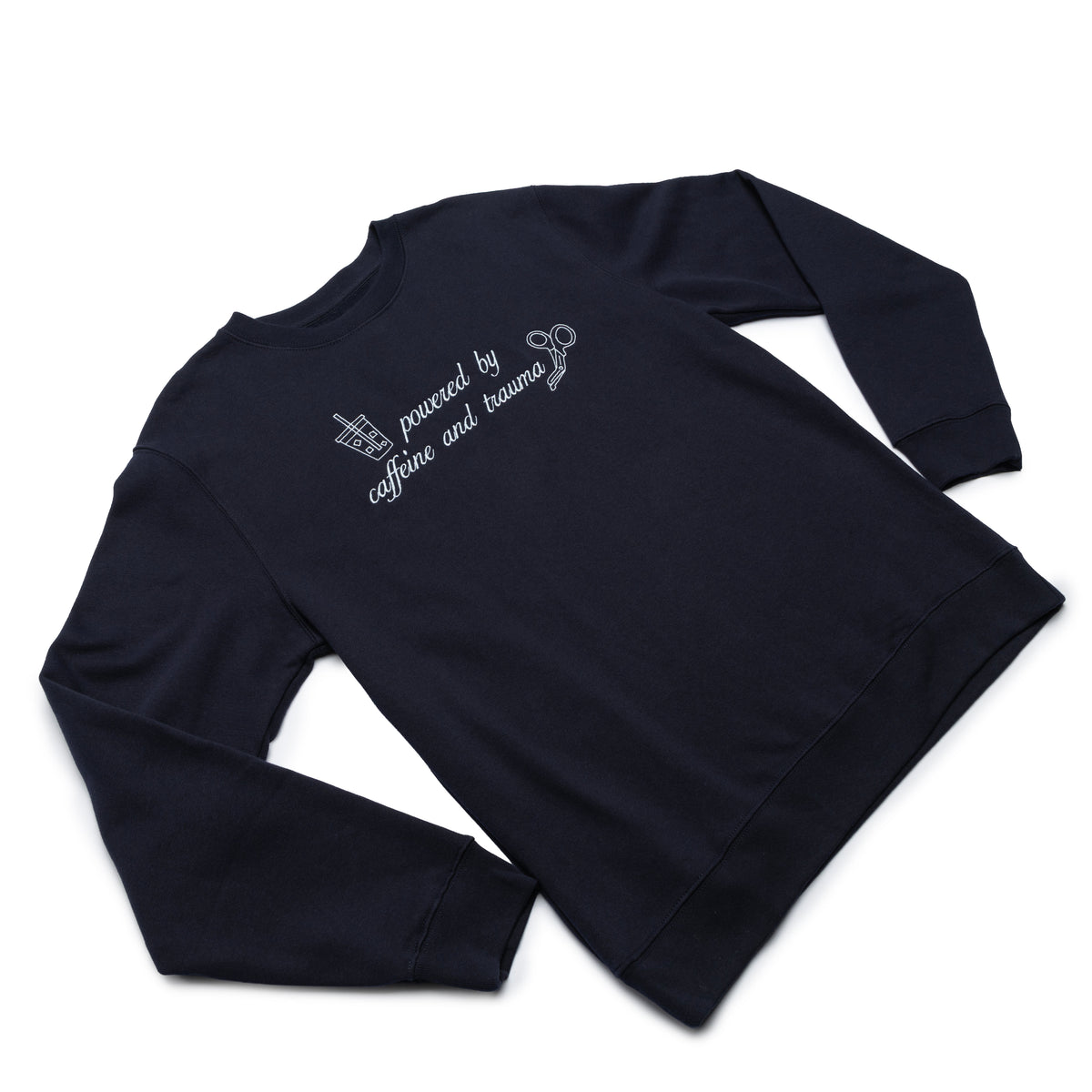 Classic Navy crewneck worn at an angle with the Powered by Caffeine and Trauma design embroidered on the chest