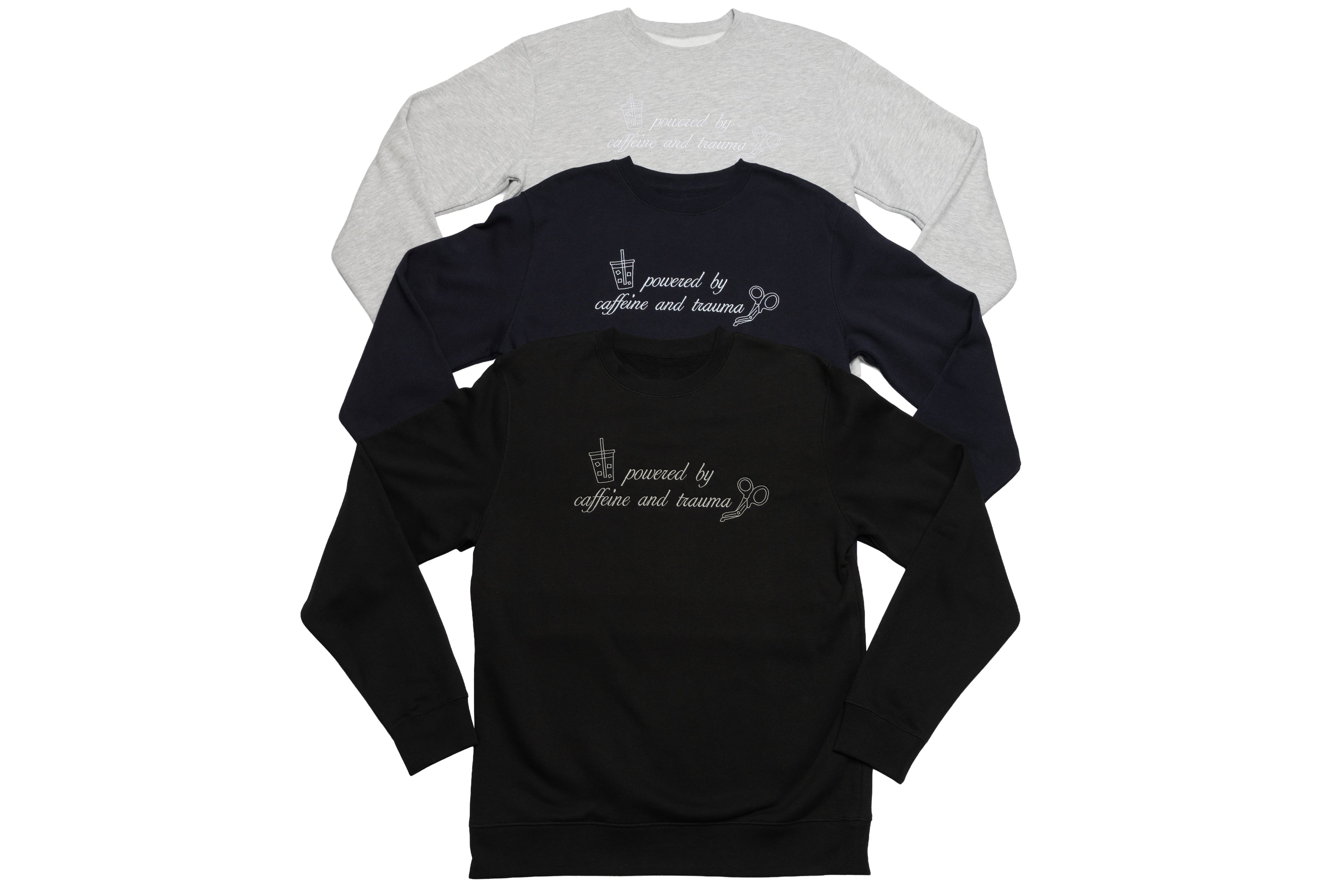 Three Shift Fuel crewnecks laid flat side by side